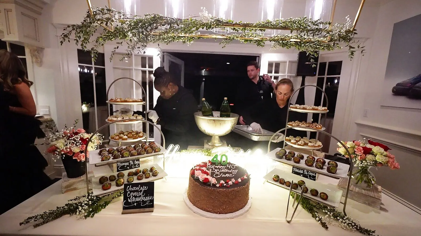 Elegant dessert table with chocolate-covered strawberries and birthday cake by Tracy Catering Company