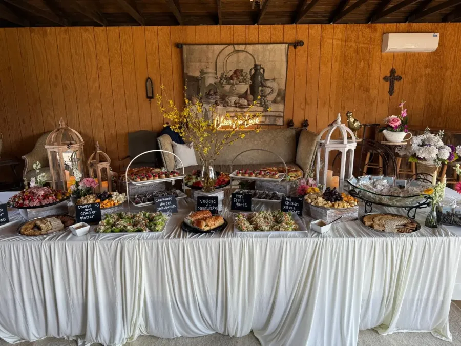 Grazing table of charcuterie, finger sandwiches, fruit tarts and salads styled with coordinated linens — grazing tablescapes for Tracy catering